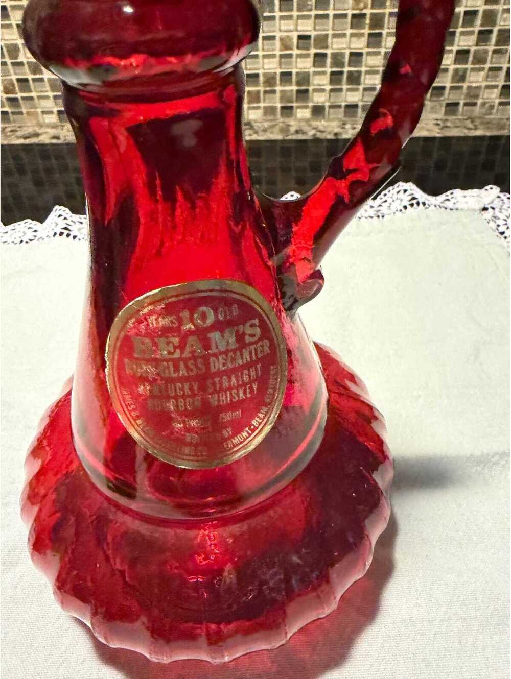 This is a vintage 1970s Jim Beam ruby red glass genie decanter.